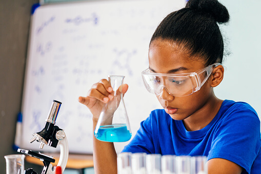 A junior high student works in a science lab.